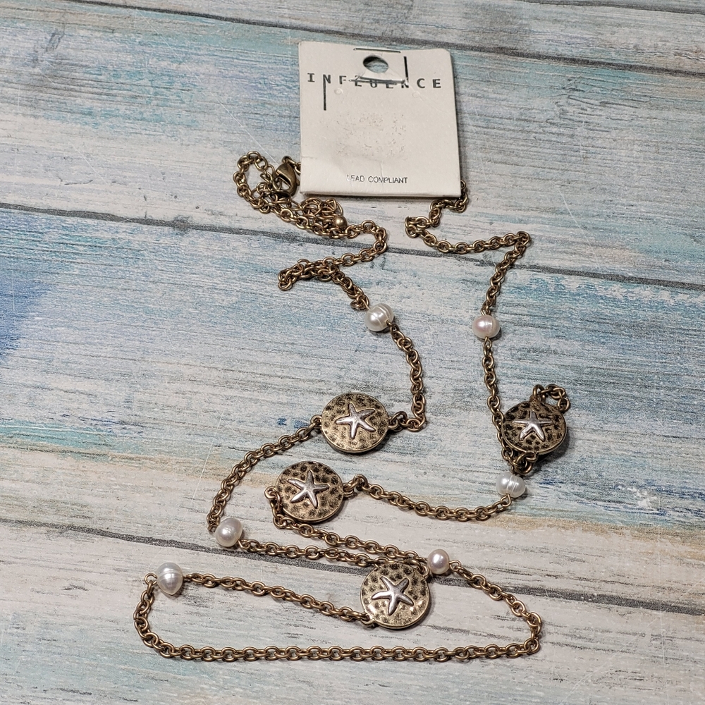 Gold Necklace with Stars and Pearl Accents.